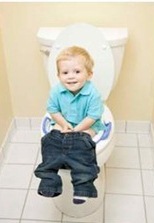 Little boy sitting on toilet learning for potty training a bowel movement
